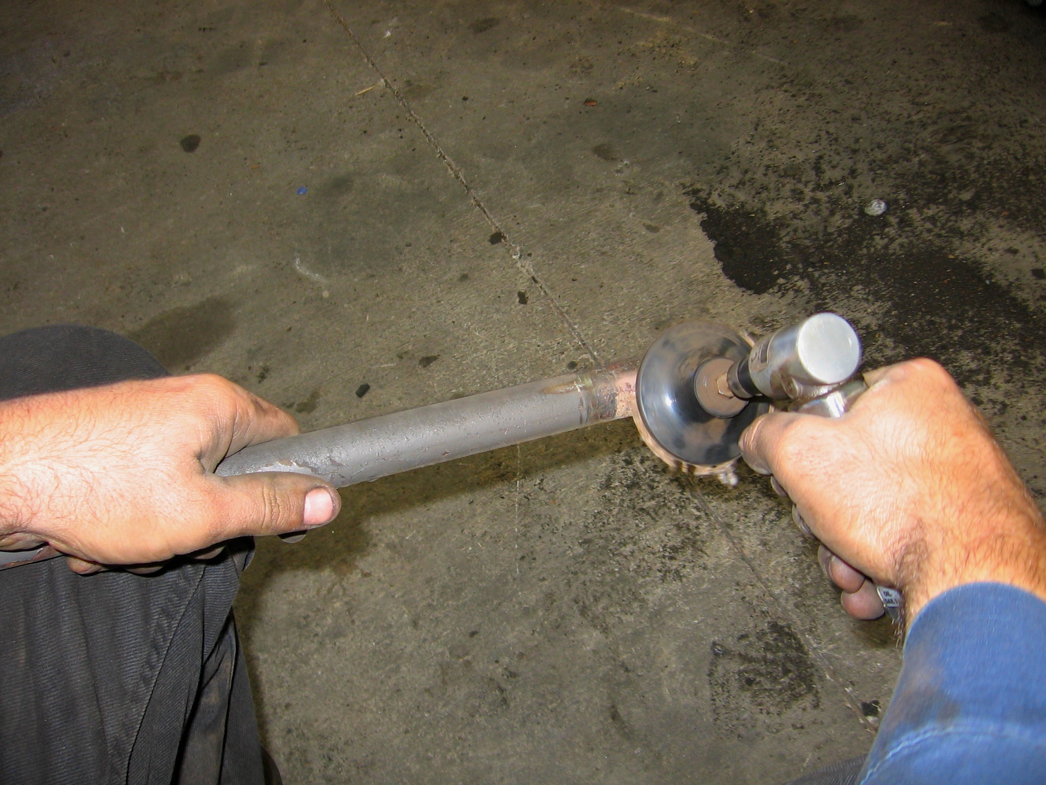 person using a tool for welding repair work